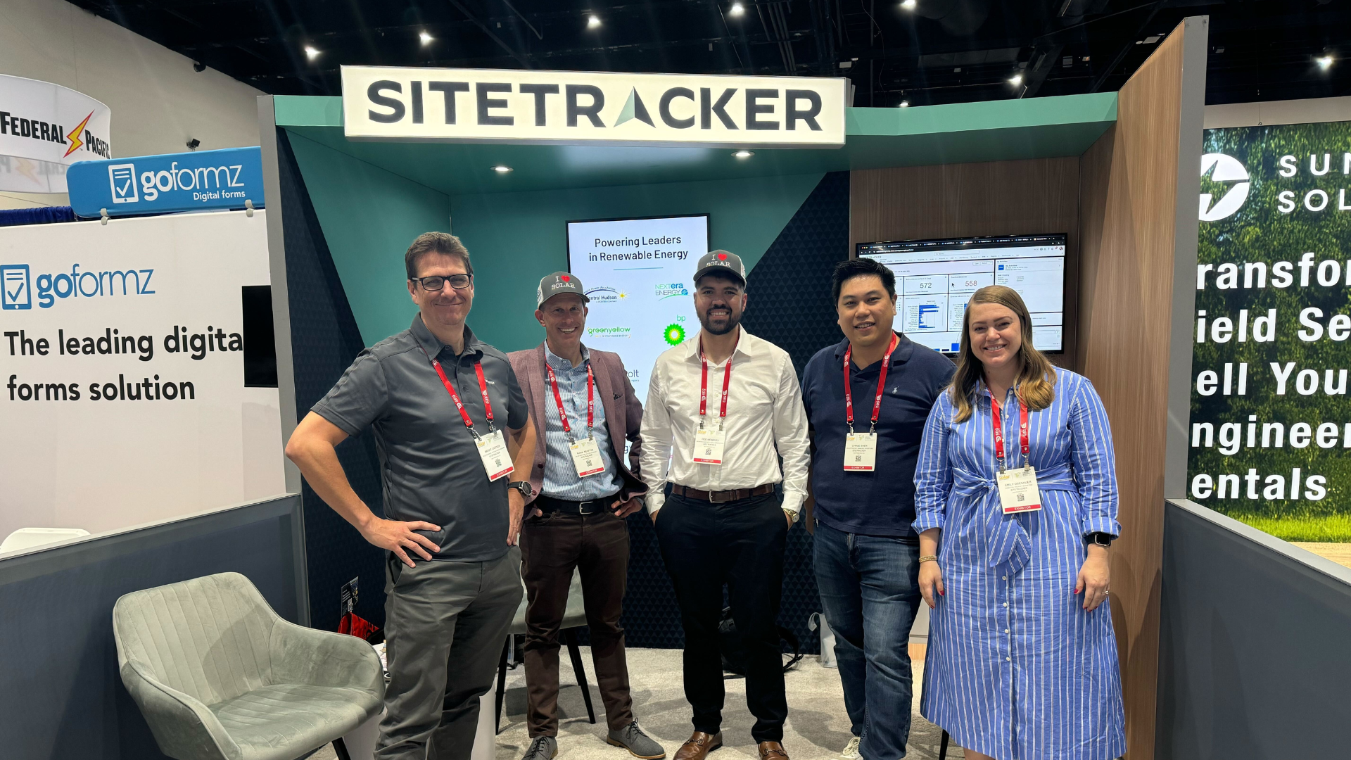 A group of Sitetracker employees poses in the event booth at Intersolar 2025